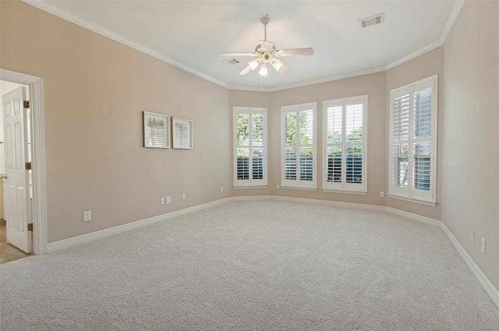 2704 Horsehead Crossing, Southlake, TX 76092 Spacious room featuring neutral carpeting, a central ceiling fan with integrated lighting, and bay-style windows dressed with white plantation shutters