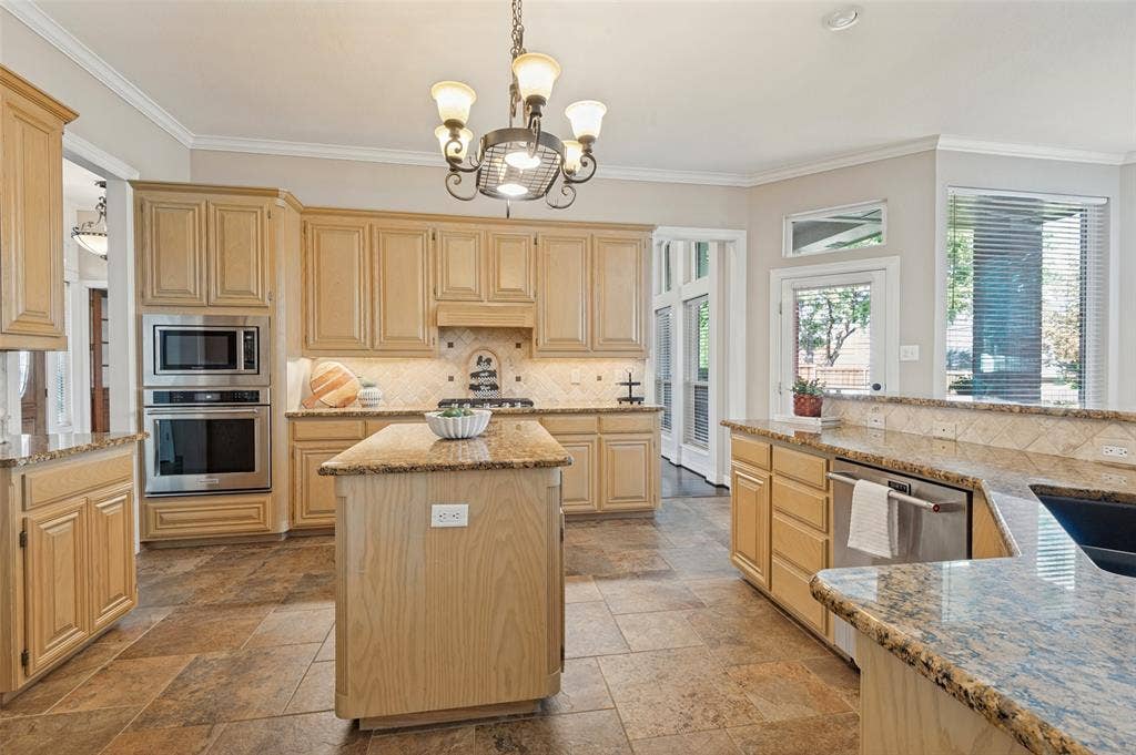 2704 Horsehead Crossing, Southlake, TX 76092 Kitchen featuring light-finish cabinetry, stone-style countertops, tile flooring, a central island, and stainless steel double wall ovens