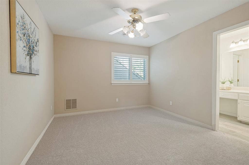 2704 Horsehead Crossing, Southlake, TX 76092 Neutral-toned interior space featuring wall-to-wall carpeting, an overhead ceiling fan with multi-light fixture, and plantation-style window shutters