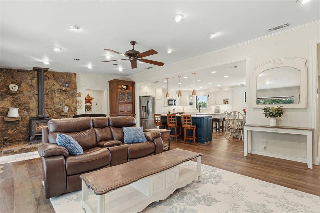 Open-concept living area featuring a wood-finish plank floor, recessed lighting, and ceiling fan