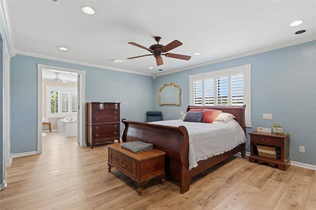 Recessed lighting, wood-finish flooring, ceiling fan, crown molding, and plantation shutters