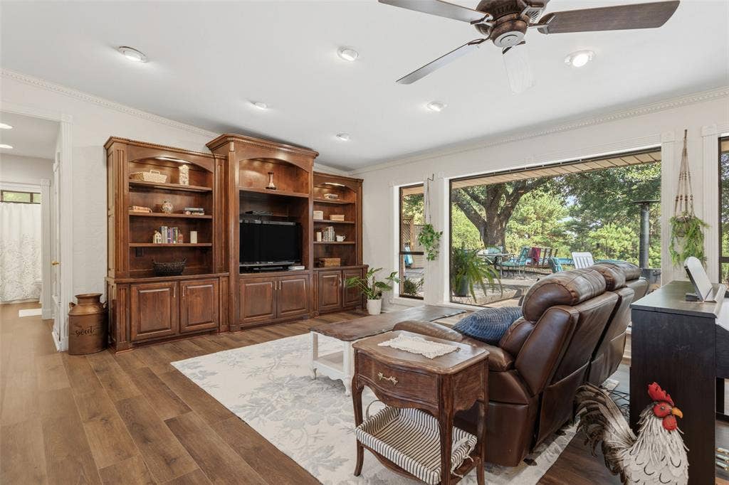 Wood-finish flooring, recessed lighting, and a ceiling fan