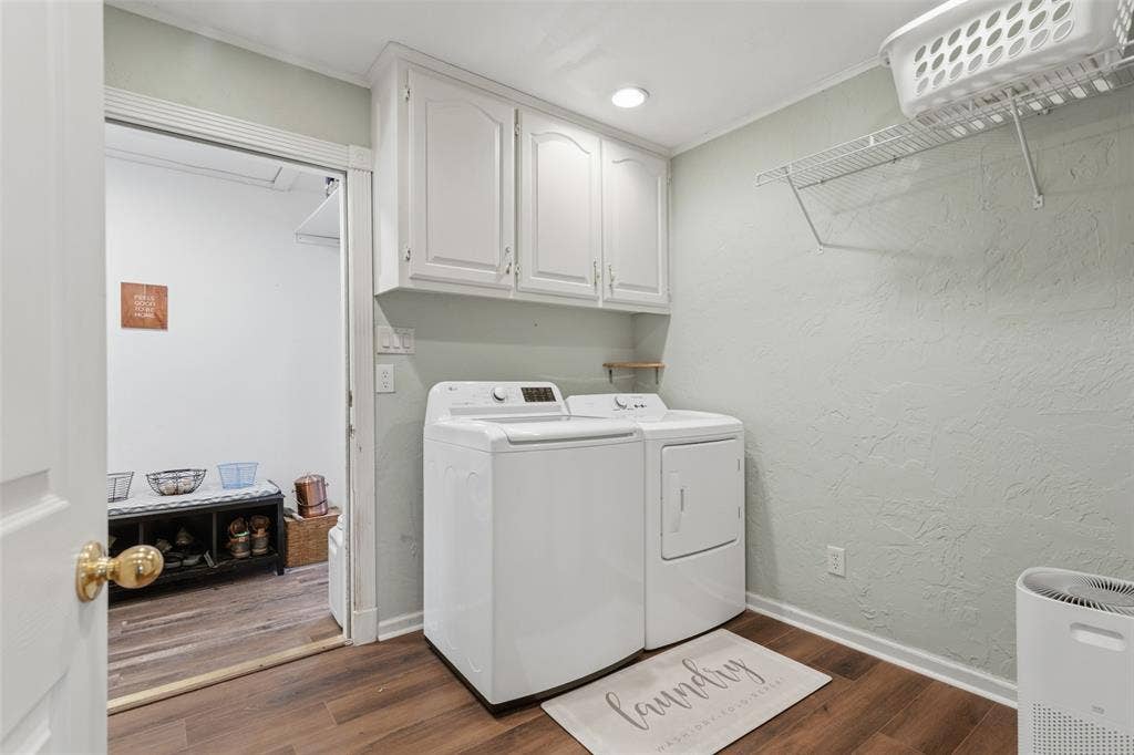 White upper cabinetry, wood-finish flooring, and a wire storage shelf