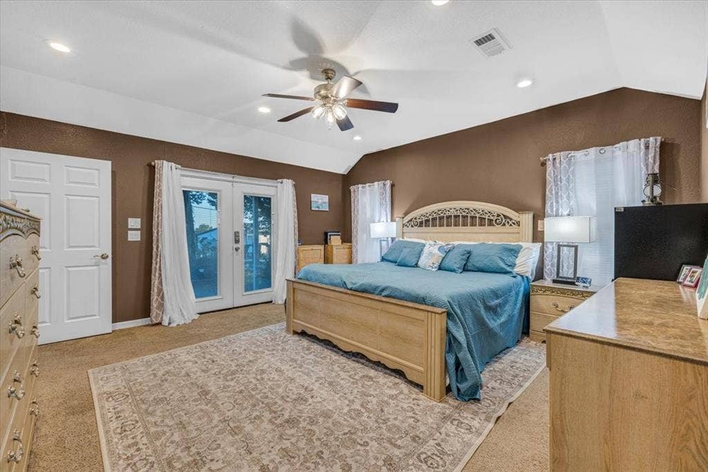 1106 Scenic Drive, Granbury, TX 76048 Vaulted ceiling with integrated recessed lighting, central ceiling fan, and double glass-paned doors