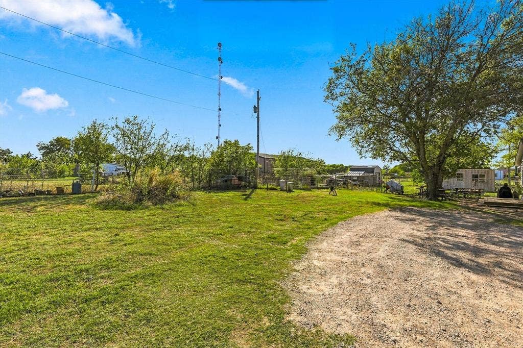 1320 Apple Lane, Midlothian, TX 76065 Expansive grounds featuring a gravel driveway, open green space, mature trees, and perimeter fencing