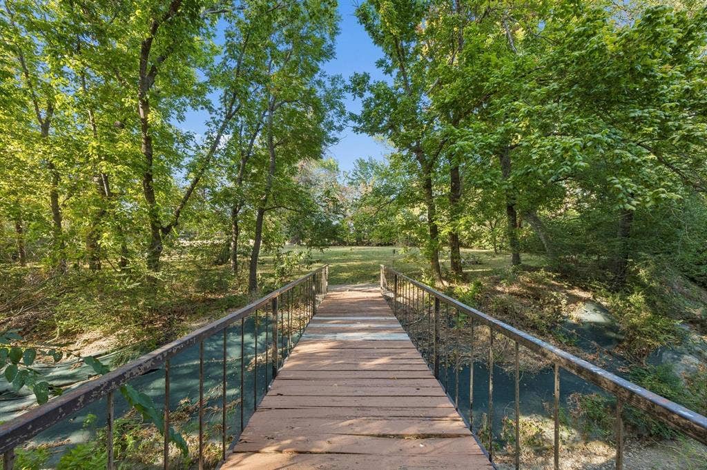 7750 Cottonwood Street, Frisco, TX 75033 A charming bridge crosses the creek and adds to the property's one-of-a-kind character.