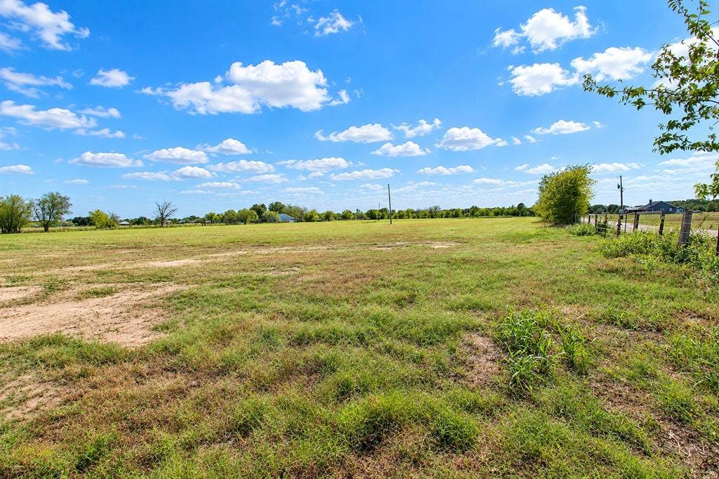 7697 County Road 4094, Scurry, TX 75158 Expansive open acreage featuring native grasses, mature perimeter trees, and post-and-wire fencing