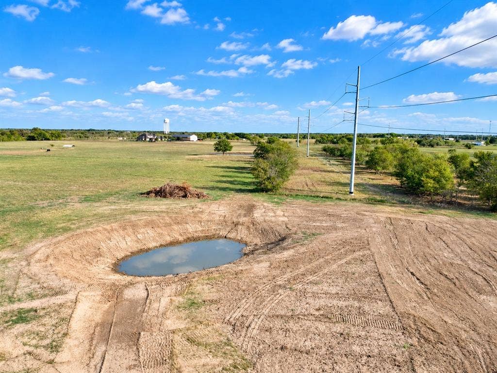 7697 County Road 4094, Scurry, TX 75158 Expansive acreage featuring open pastureland, a natural pond, and mature tree clusters