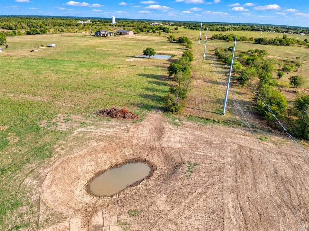 7697 County Road 4094, Scurry, TX 75158 Expansive acreage featuring cleared pasture land, two ponds, and mature tree clusters