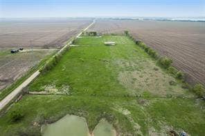 Lot 3 Bozek Lane, Ennis, TX 75119 Expansive green space featuring a natural pond, a long private driveway, and clear, flat terrain