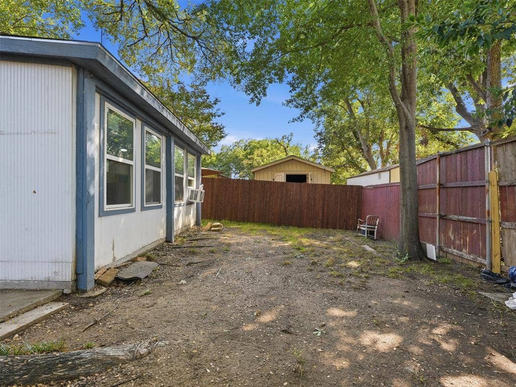 1402 Addington Street, Irving, TX 75062 Exterior siding with multiple windows, surrounded by mature trees