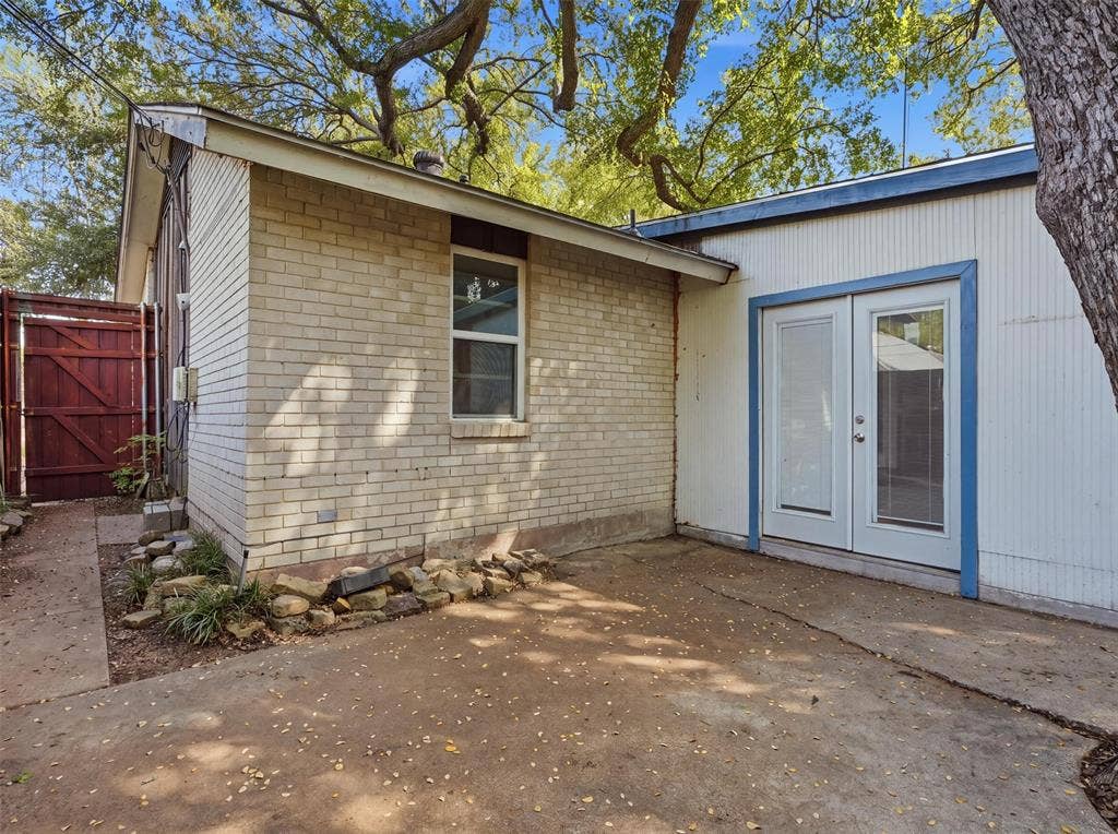 1402 Addington Street, Irving, TX 75062 Brick and panel siding exterior with a concrete patio