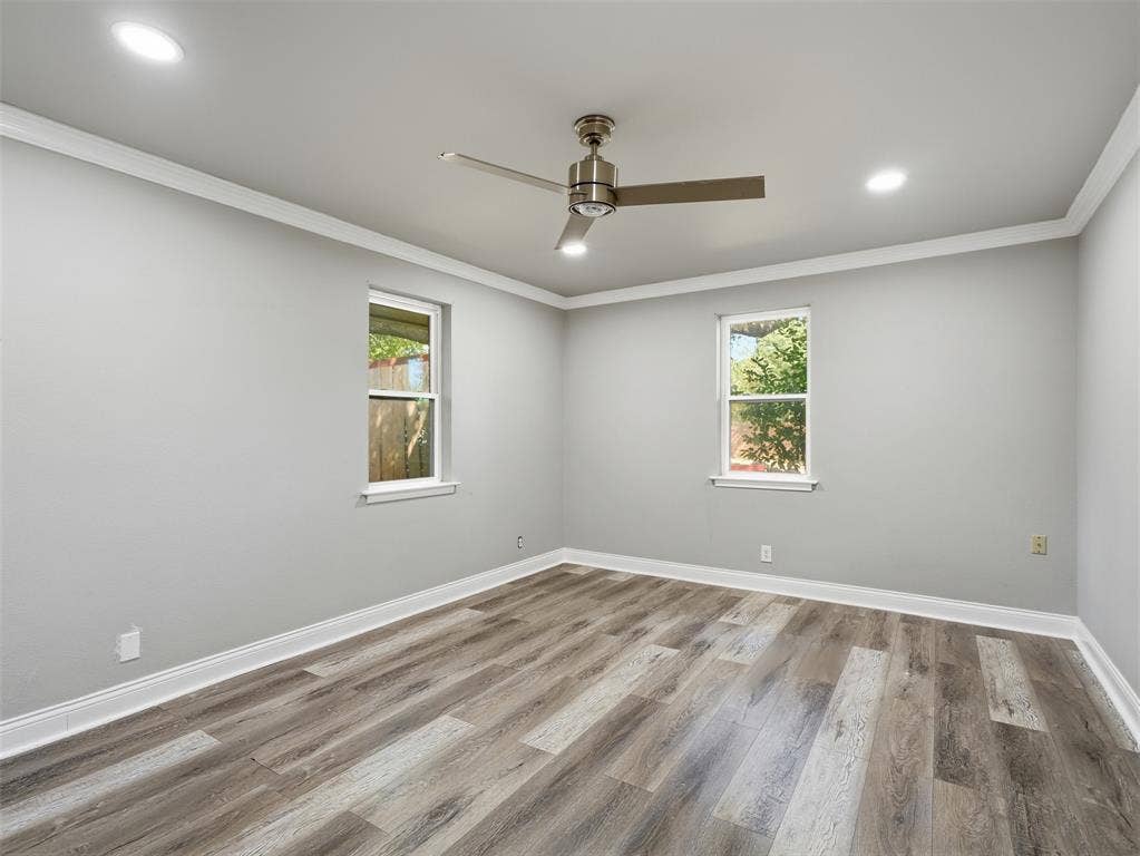 1402 Addington Street, Irving, TX 75062 Wood-finish flooring, recessed lighting, crown molding, and a ceiling fan with light fixture
