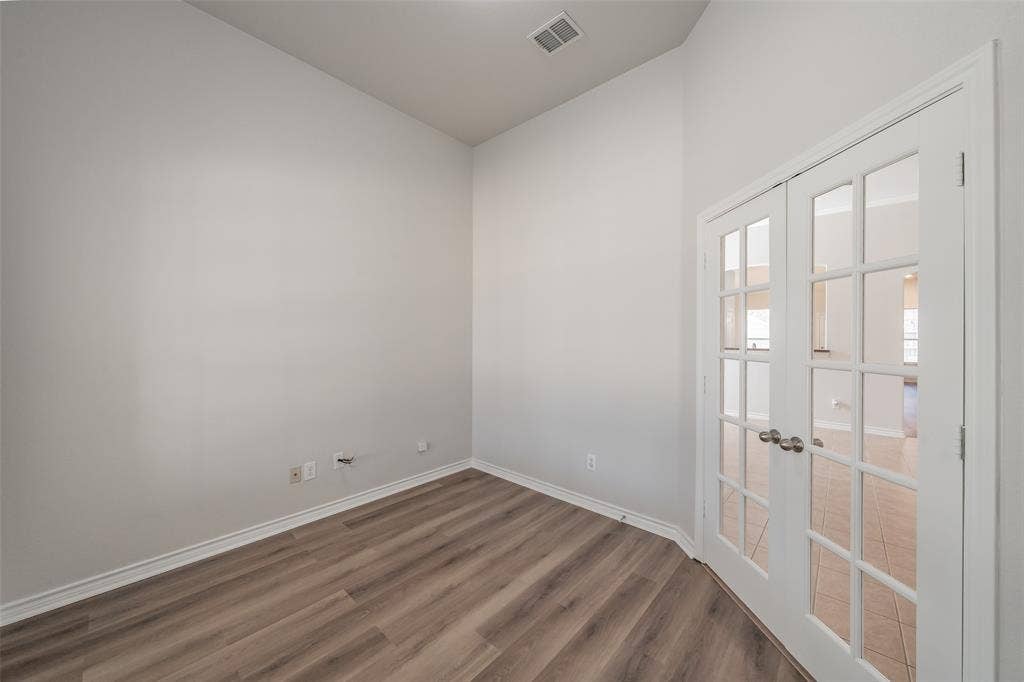 2205 Clairborne Drive, Fort Worth, TX 76177 Wood-finish flooring with white baseboards, white walls, and a vaulted ceiling