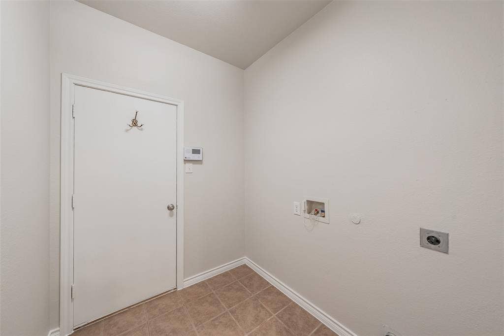 2205 Clairborne Drive, Fort Worth, TX 76177 Utility area with a white door, tile flooring, and appliance hookups