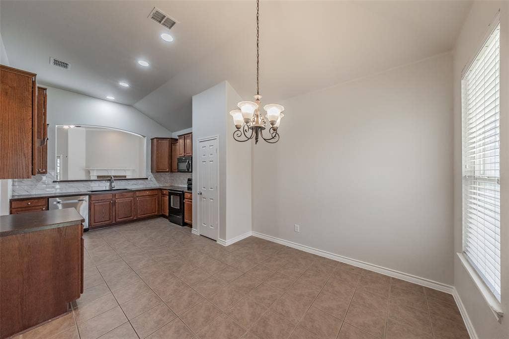 2205 Clairborne Drive, Fort Worth, TX 76177 Kitchen featuring wood cabinetry, stainless steel appliances, tile flooring, and a pass-through window