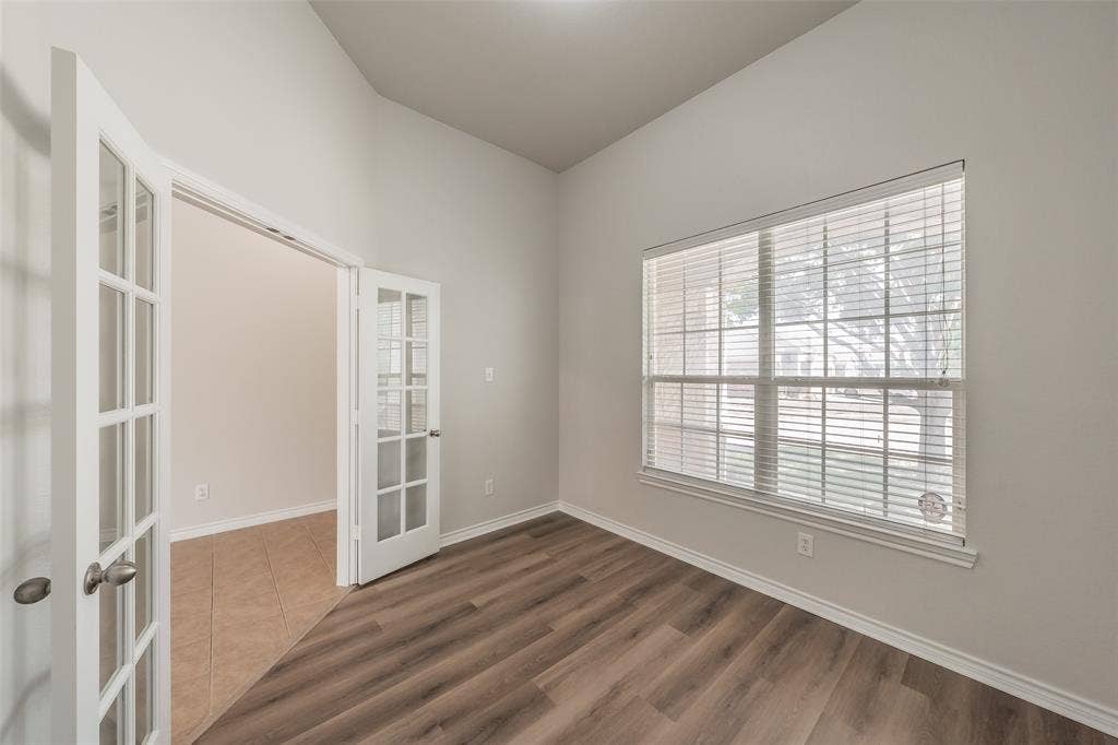 2205 Clairborne Drive, Fort Worth, TX 76177 Vaulted ceiling, wood-finish flooring, white trim, window with blinds, and French doors