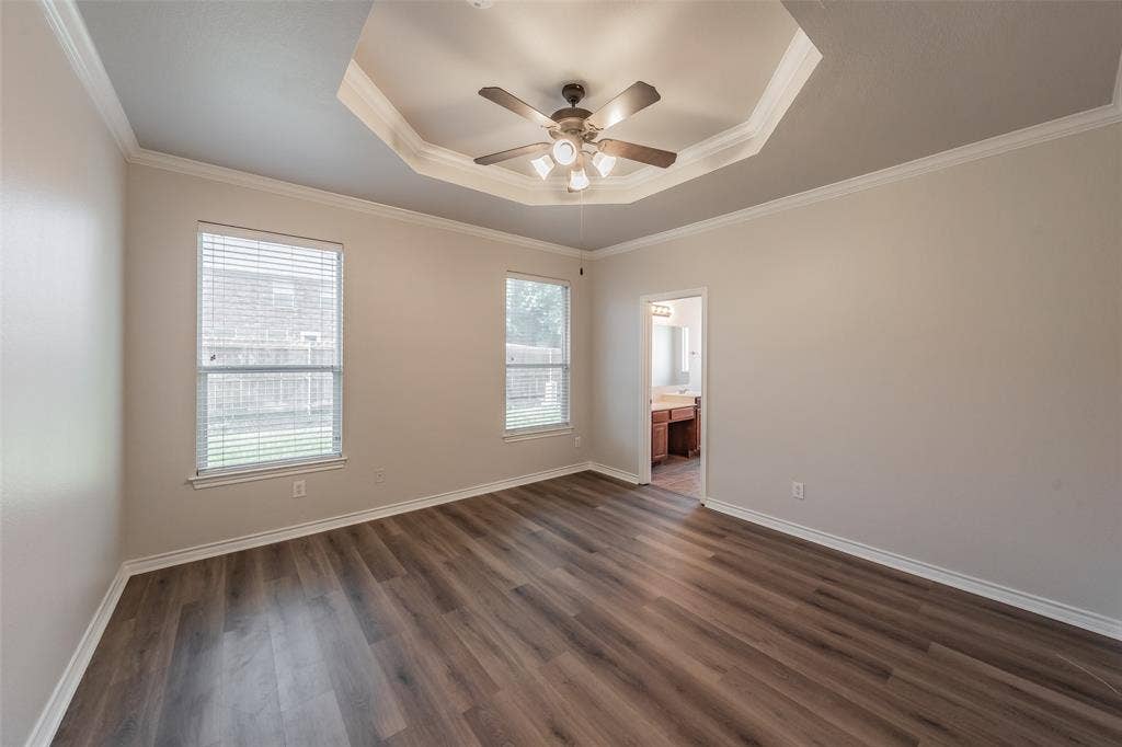 2205 Clairborne Drive, Fort Worth, TX 76177 Spacious bedroom with recessed ceiling detail and integrated ceiling fan with lighting