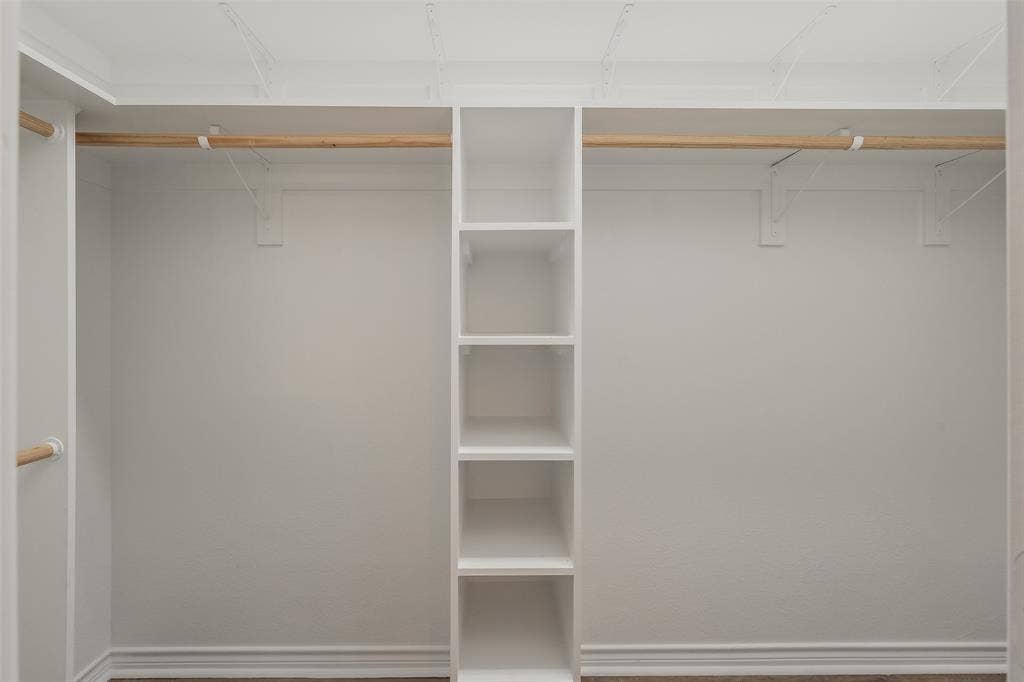 2205 Clairborne Drive, Fort Worth, TX 76177 White built-in shelving with multiple cubbies, wood-finish flooring, and white walls