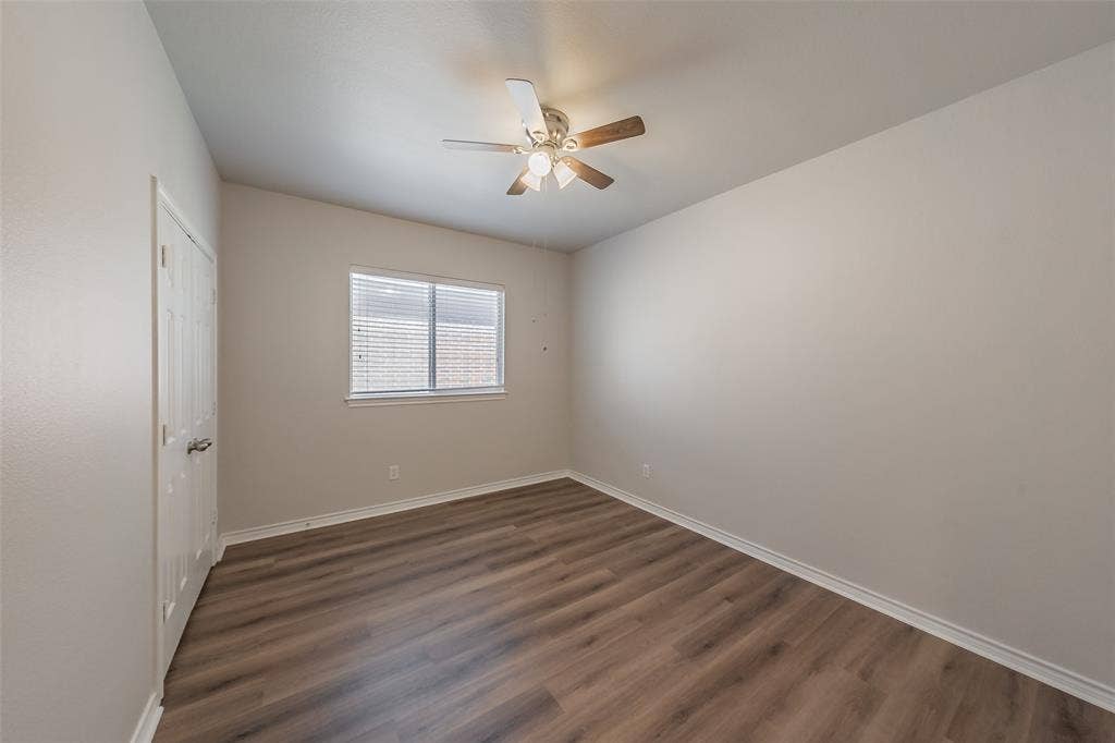 2205 Clairborne Drive, Fort Worth, TX 76177 Wood-finish flooring, neutral wall tones, window with blinds, white trim, and ceiling fan with integrated lighting