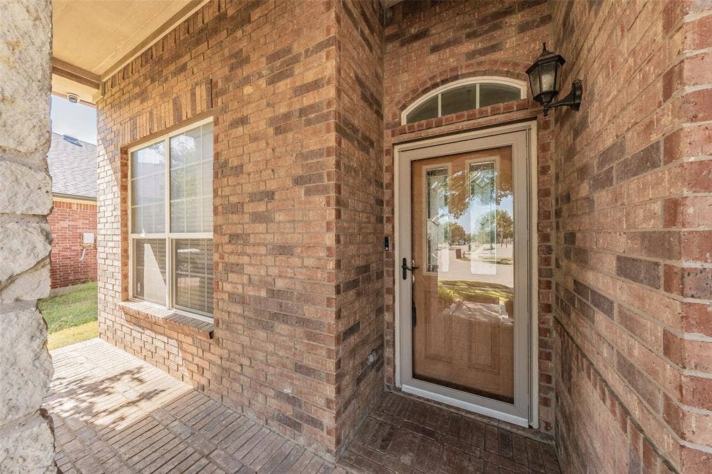 2205 Clairborne Drive, Fort Worth, TX 76177 Brick exterior facade with a stone column accent