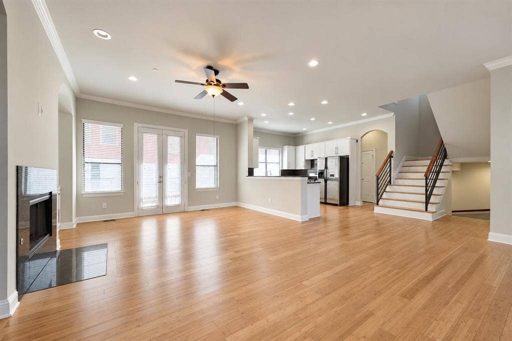 4432 Bowser Avenue, #C, Dallas, TX 75219 Light wood-finish flooring throughout, recessed lighting, and a modern fireplace with a black surround