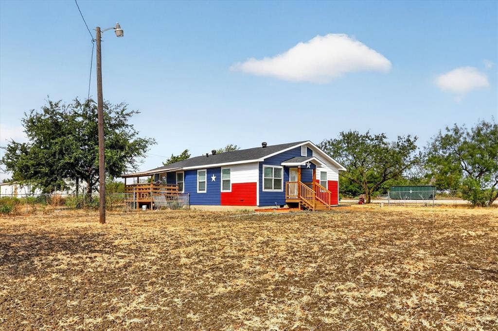 Single-story residence featuring a distinctive red, white, and blue exterior
