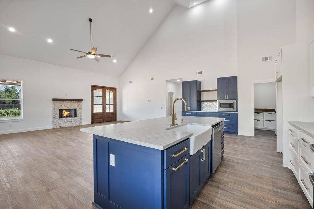 Large island with farmhouse sink and gold fixtures