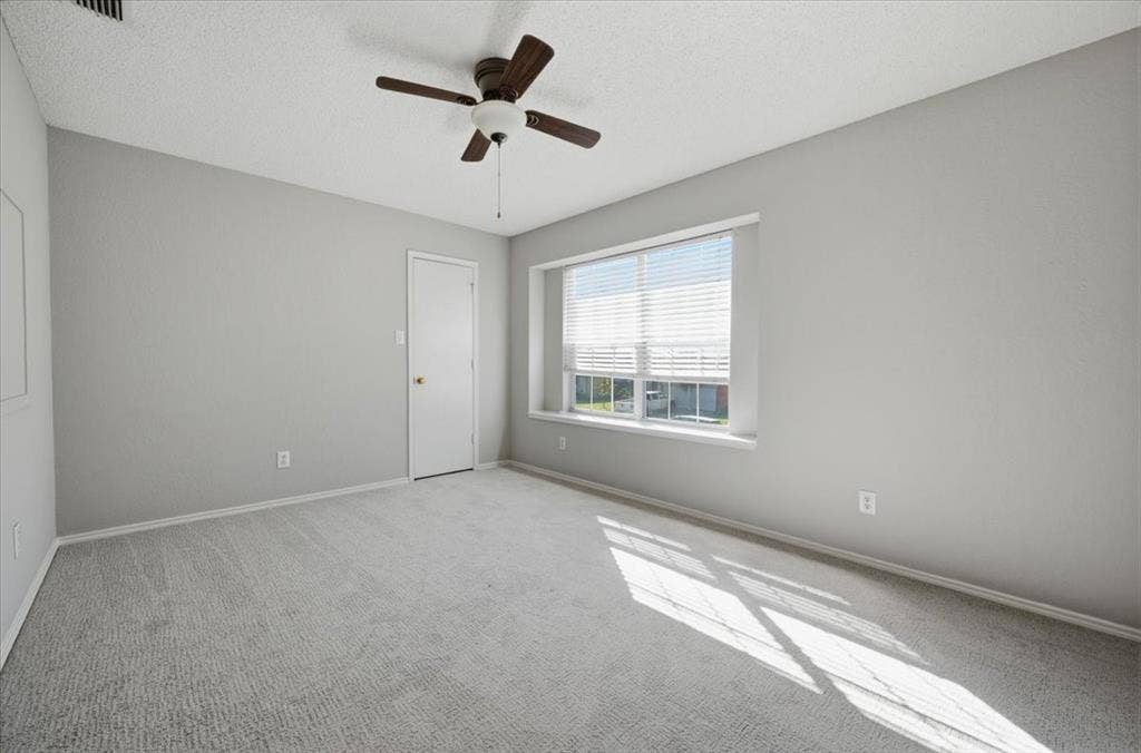 5016 Mill Creek Trail, Fort Worth, TX 76179 Light grey carpeting, neutral wall color, and a ceiling fan with light