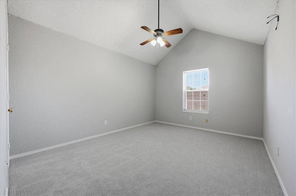 5016 Mill Creek Trail, Fort Worth, TX 76179 Vaulted ceiling with a ceiling fan, light gray wall finish, gray carpet flooring, and a window with blinds