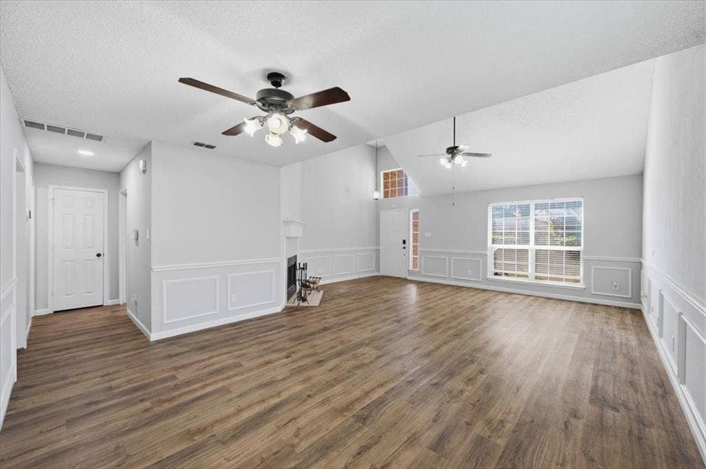 5016 Mill Creek Trail, Fort Worth, TX 76179 Vaulted ceilings, wood-finish flooring, wainscoting, fireplace with mantel, and ceiling fans