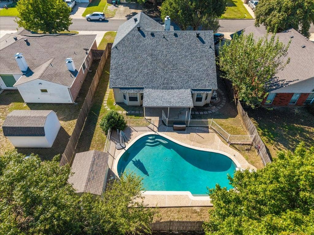 5016 Mill Creek Trail, Fort Worth, TX 76179 Fenced backyard featuring an in-ground swimming pool, covered patio, and a utility shed