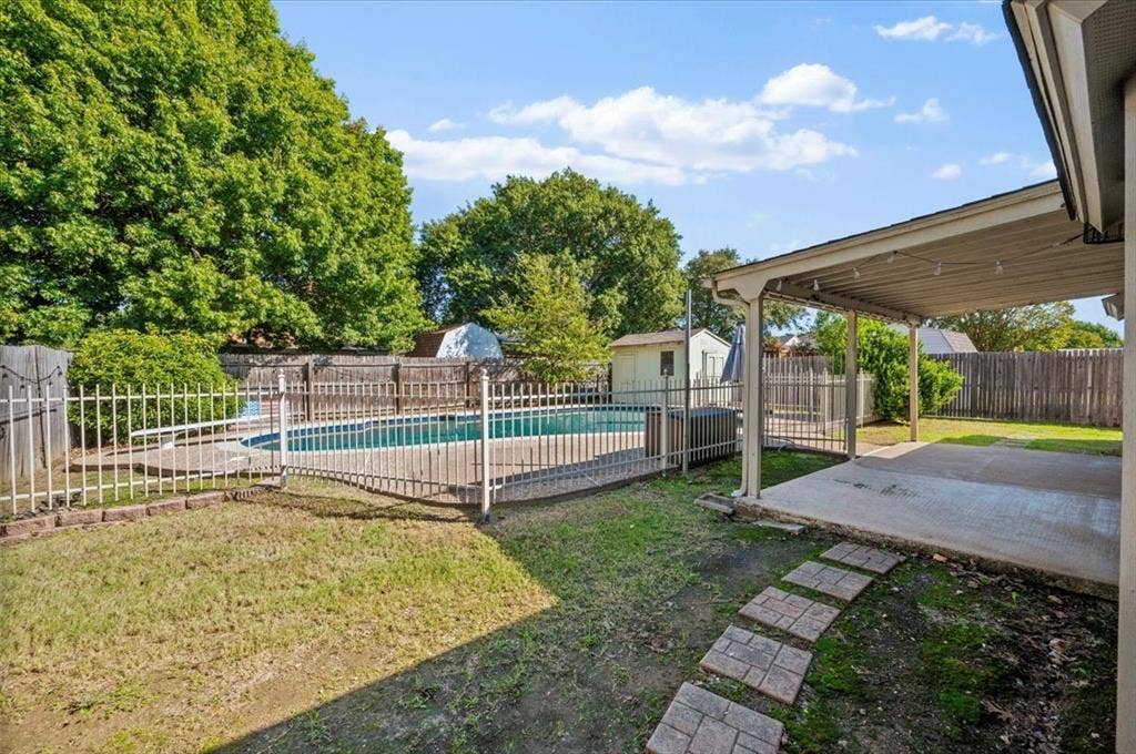 5016 Mill Creek Trail, Fort Worth, TX 76179 Backyard featuring a covered patio, concrete slab, and a swimming pool with a surrounding fence