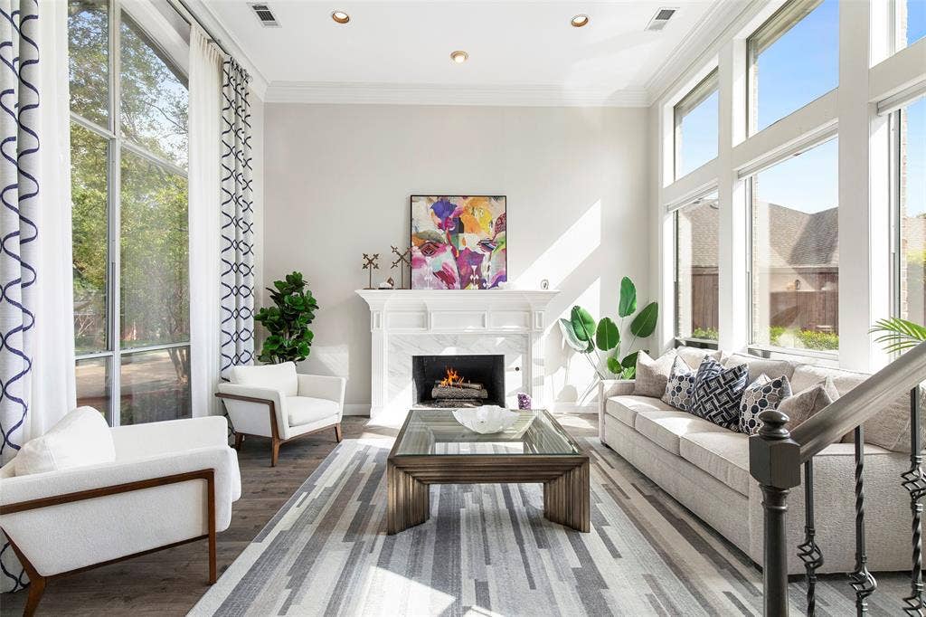 Spacious and bright the entry opens to the soaring front living room, with an iron-baluster staircase adding architectural detail.