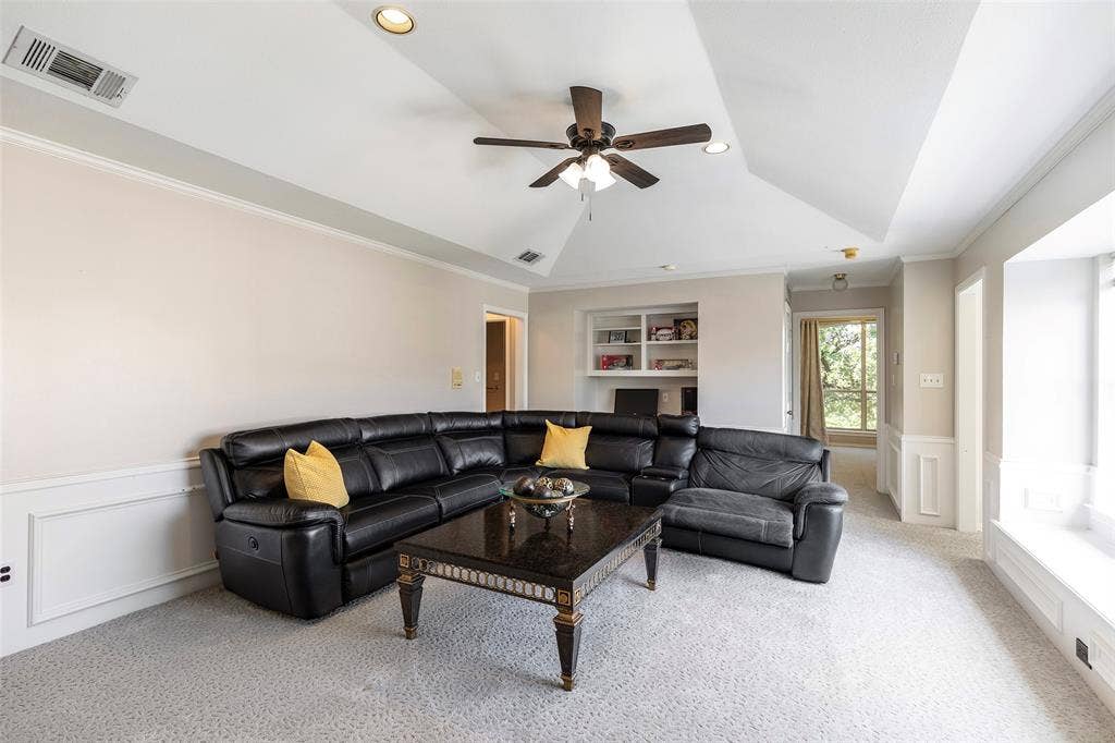 The upstairs gathering space is an inviting spot for football Sundays and movie nights, while a built-in desk and shelving provide a handy homework or computer nook.