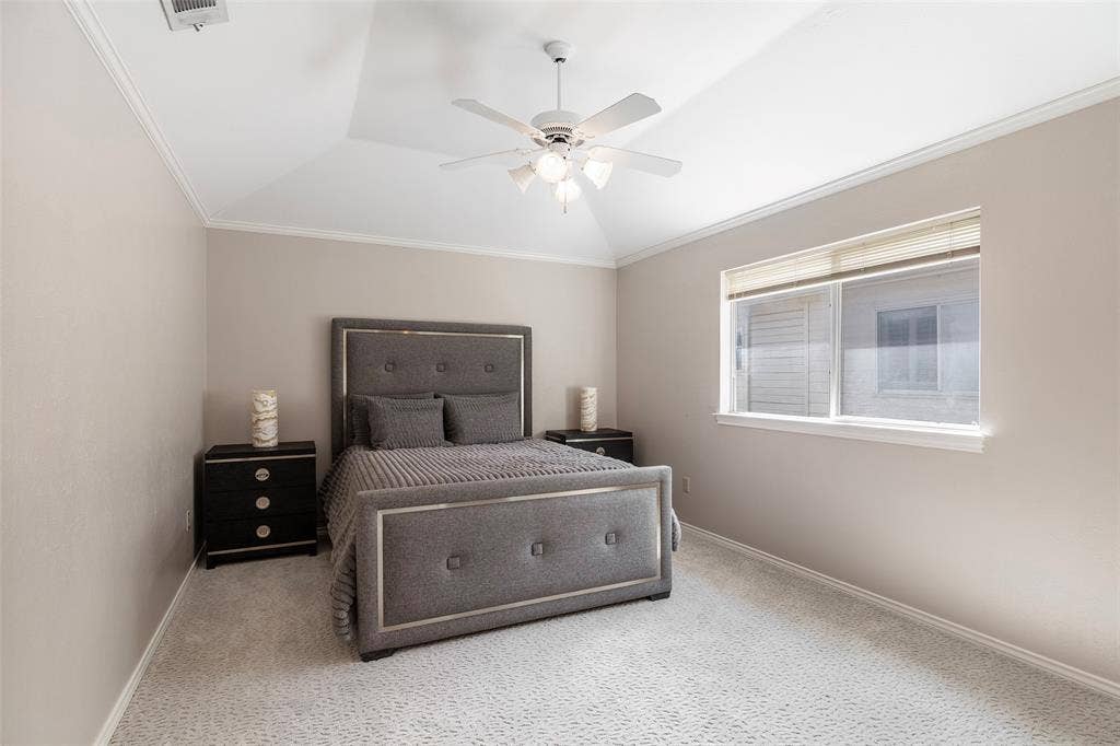 A raised ceiling and a large window give this upstairs bedroom an airy feel, with neutral finishes ready for your personal touch.