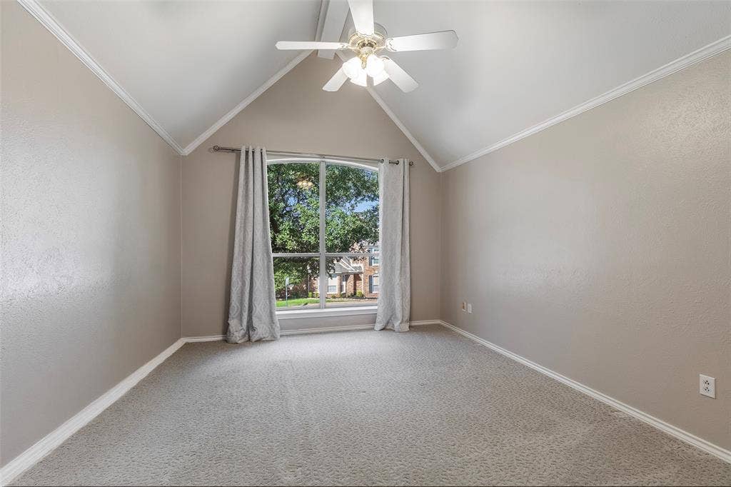 A vaulted ceiling and tall arched window give this upstairs bedroom character, with leafy views and space to make your own.