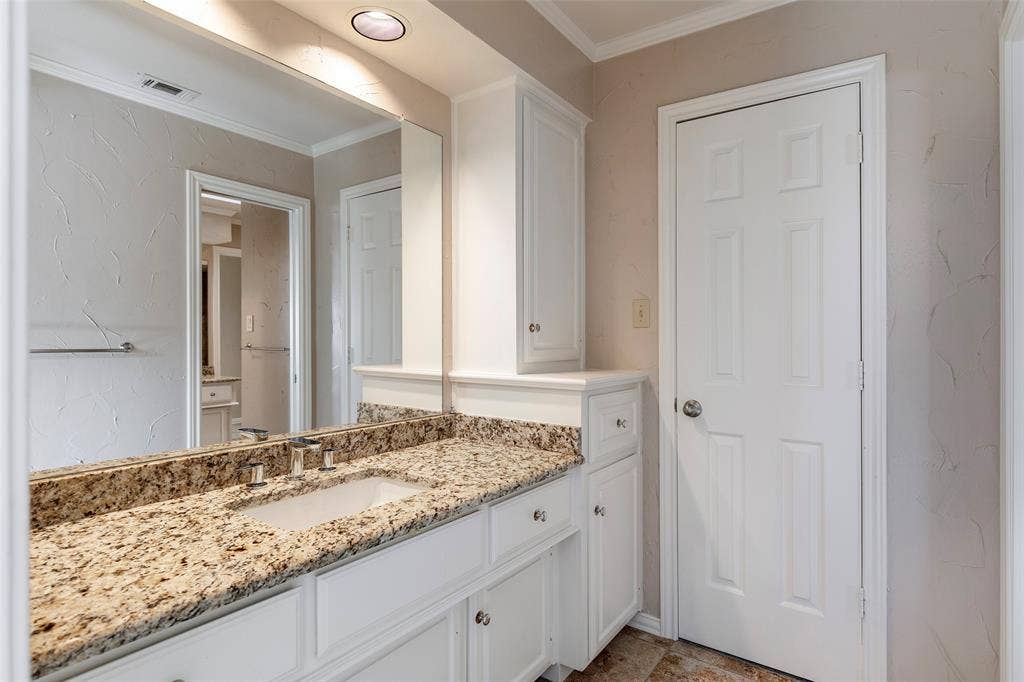 Jack and Jill vanity with built-in storage provides a dedicated place to get ready, with access to the shared tub, shower