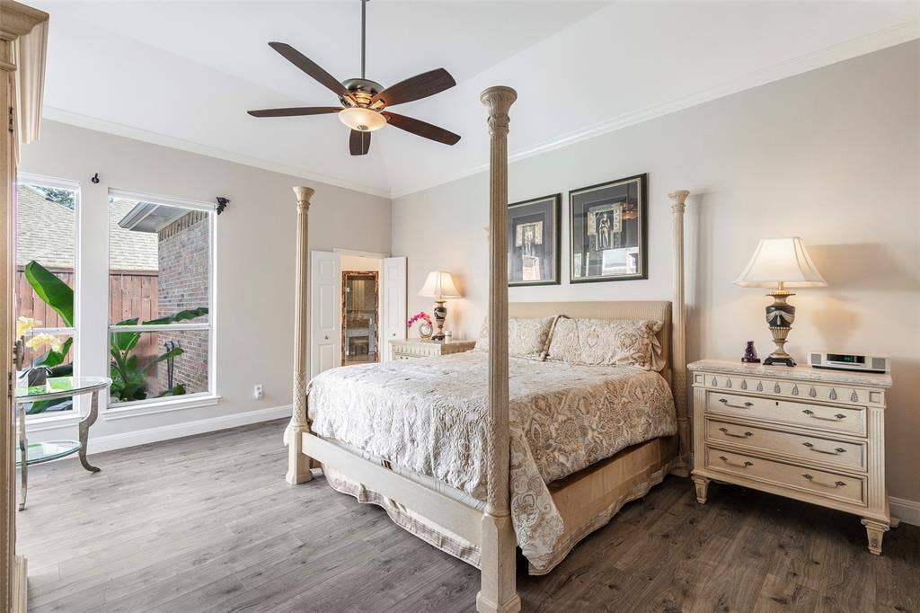 High ceilings, tall windows and room for king-size furnishings create a comfortable primary retreat with an adjoining bath.