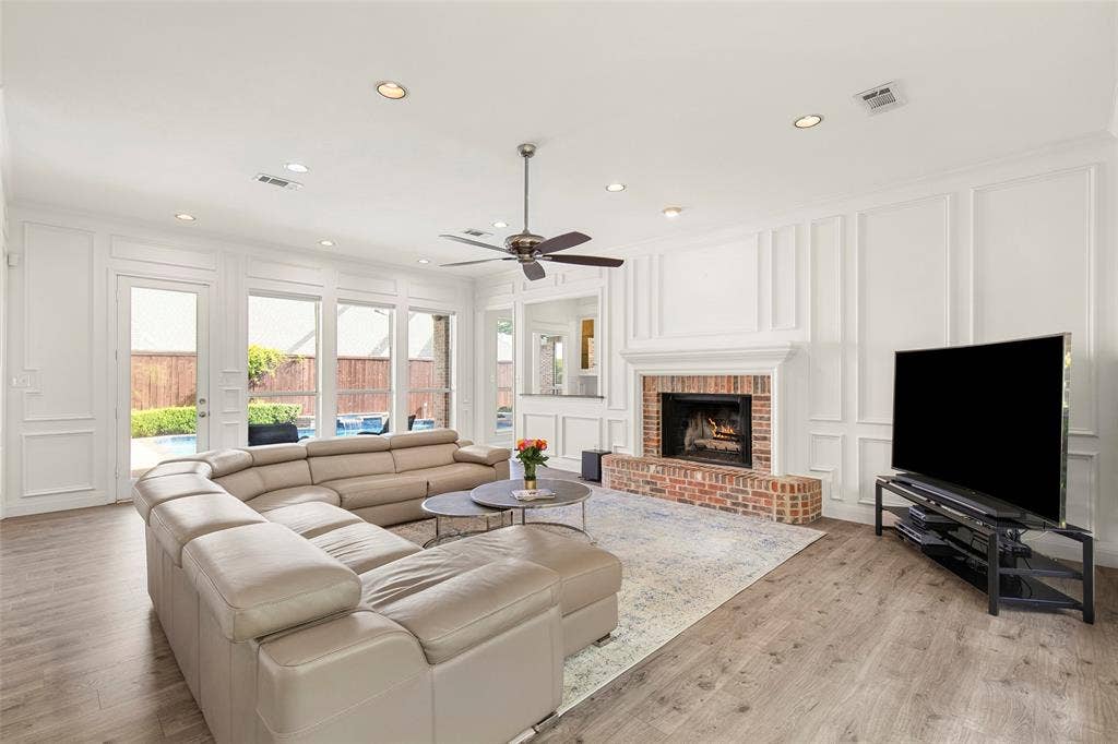 Soaring windows draw your eyes out toward the private backyard oasis and pool, flooding the main living area with beautiful natural light.