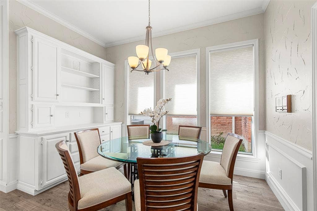 The window-lined breakfast nook pairs casual dining space with built-in cabinetry and open shelving for dishes, serving pieces or favorite collections.