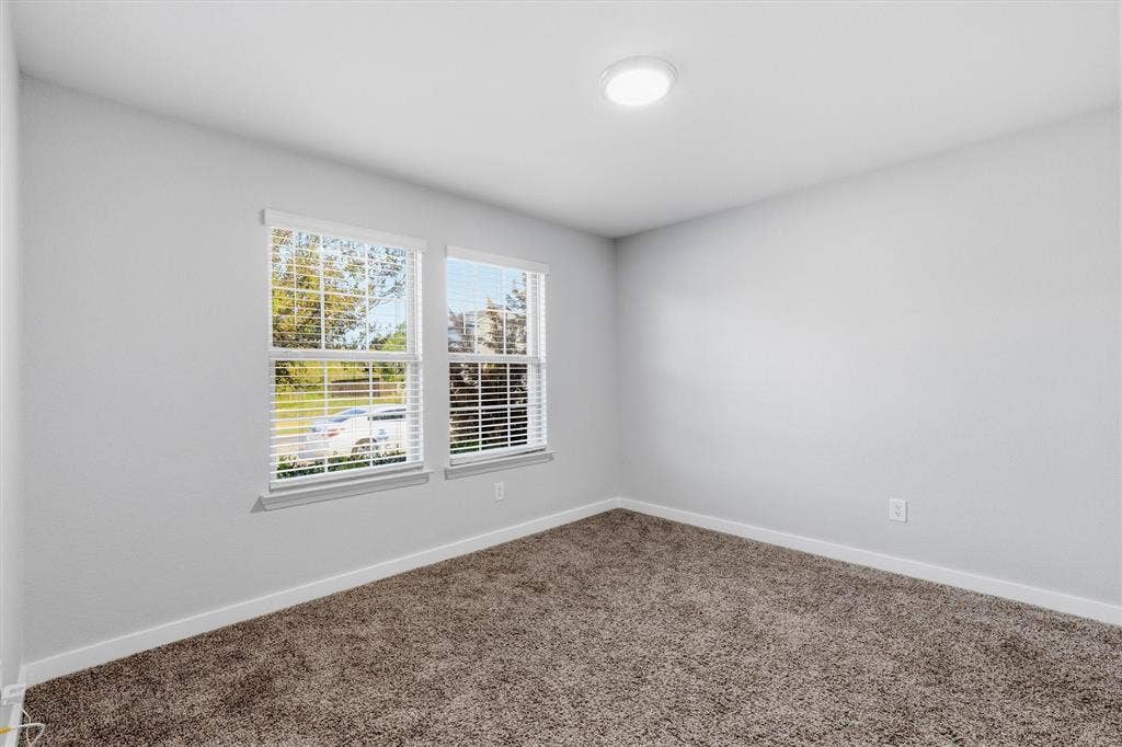2333 Bellewood Court, Crandall, TX 75114 Two windows with horizontal blinds, overhead flush-mount lighting, and wall-to-wall carpeting