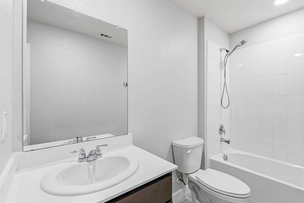 2333 Bellewood Court, Crandall, TX 75114 Vanity with an integrated sink, polished chrome faucet, and a large wall-mounted mirror