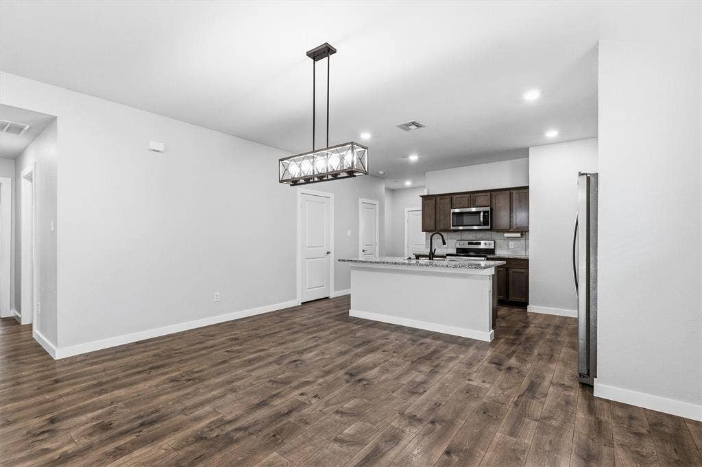 2333 Bellewood Court, Crandall, TX 75114 Open-concept living area with wood-finish flooring, a contemporary chandelier, and recessed lighting