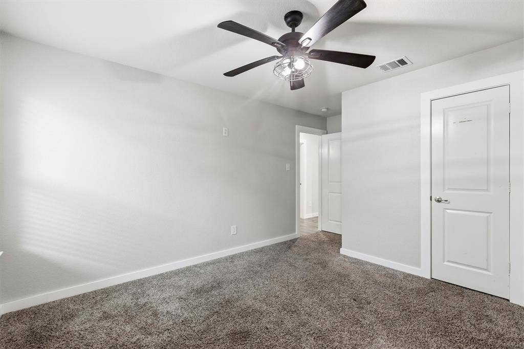 2333 Bellewood Court, Crandall, TX 75114 Plush carpet flooring, neutral wall tones, and a ceiling fan with integrated lighting
