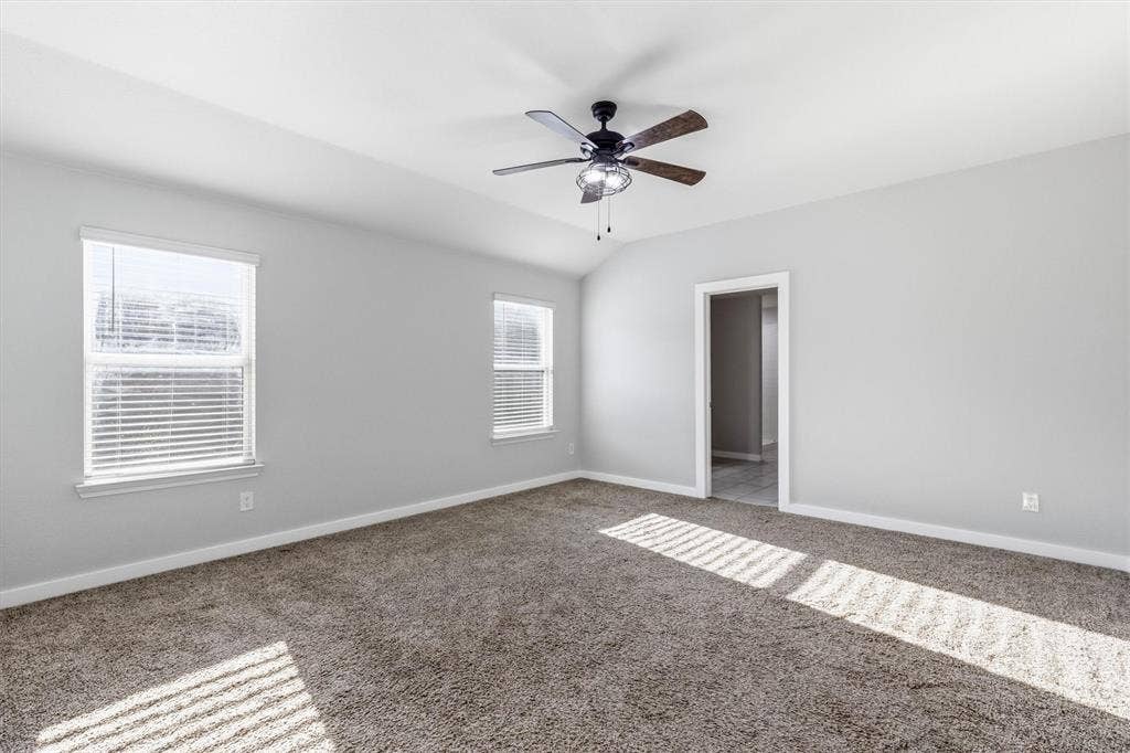 2333 Bellewood Court, Crandall, TX 75114 Carpeted flooring, vaulted ceiling, two windows with blinds, recessed lighting on ceiling fan, and painted walls