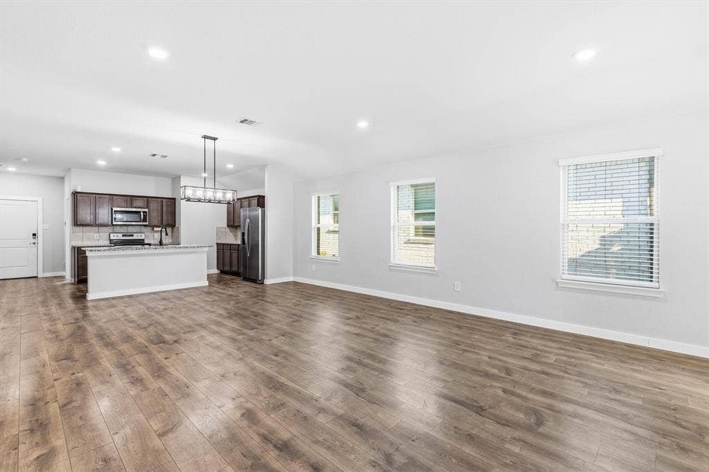 2333 Bellewood Court, Crandall, TX 75114 Spacious interior with wood-finish flooring, recessed lighting, and multiple windows