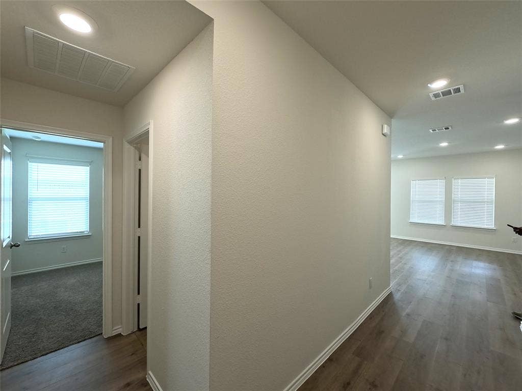1148 Samantha Drive, Dallas, TX 75253 Recessed lighting illuminates the wood-finish flooring throughout the main living areas