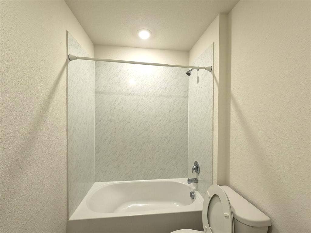 1148 Samantha Drive, Dallas, TX 75253 Recessed ceiling lighting, full-sized bathtub, integrated shower, chrome fixtures, and a white toilet