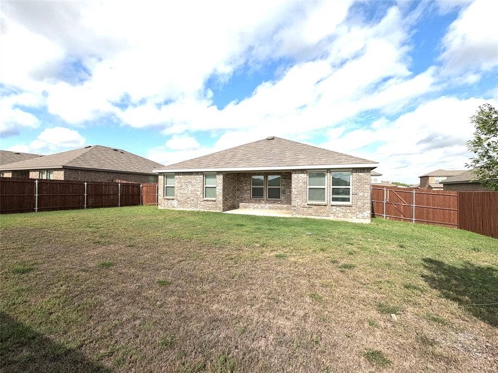 1148 Samantha Drive, Dallas, TX 75253 Brick exterior with a shingled roof, multiple windows, and a fully fenced backyard